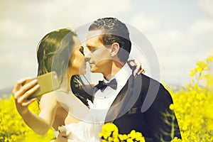 Wedding couple kiss in field yellow flowers