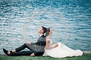 Wedding couple kissing on the background of a lake and mountains