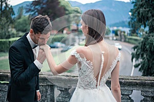 Wedding couple kissing on the background of a lake and mountains