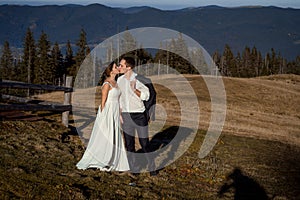 Wedding couple kissing. beautiful mountains on background