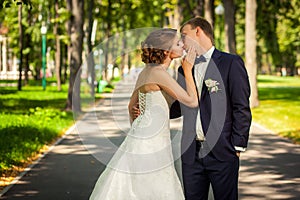 Wedding couple kissing in park