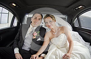 Wedding couple in Limousine