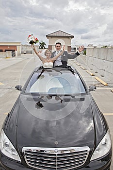 Wedding couple in Limousine sunroof