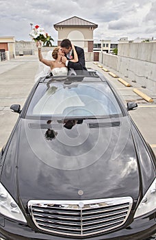 Wedding couple in Limousine sunroof