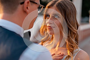 Wedding couple looking at each other with love and happiness at park at sunset time