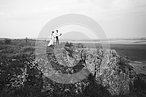 Wedding couple looking in mountain hill on sunset