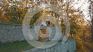 Wedding couple. Lovely groom and bride staying on a remains of a destroyed building in the forest. Happy family