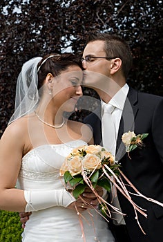 Wedding couple, man kiss brides head