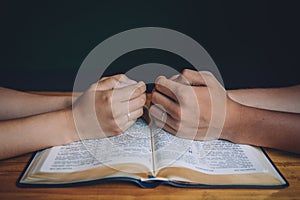 Wedding couple or marriage, praying over the open bible.