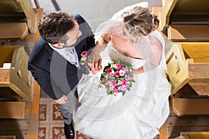 Wedding couple marrying in church photo