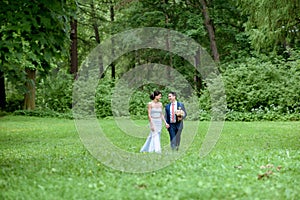 Wedding couple on the nature is walking