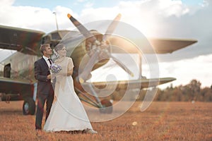 Wedding couple near vintage aircraft