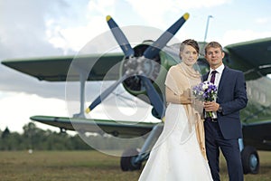 Wedding couple near vintage aircraft