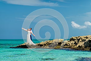 A wedding couple on an ocean shore