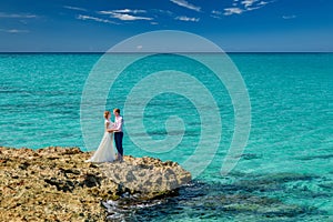 A wedding couple on an ocean shore