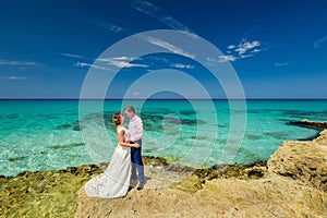 A wedding couple on an ocean shore