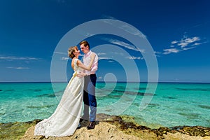 A wedding couple on an ocean shore