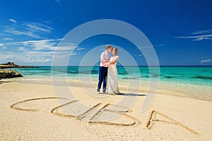 A wedding couple on an ocean shore