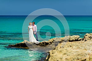 A wedding couple on an ocean shore