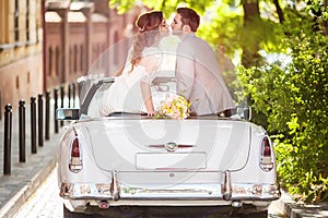 Wedding couple with old car