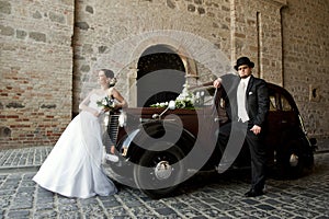 Wedding couple with old car