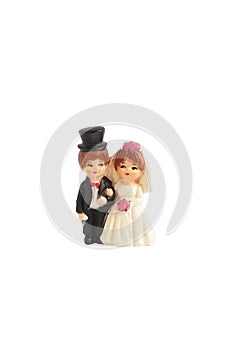 Wedding couple. A plastic toy miniature of a wedding couple isolated on white background. Love and marriage concept