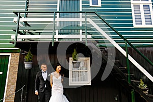 Wedding couple posing in front of a house