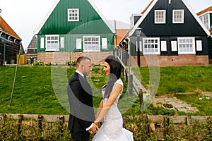 Wedding couple posing in front of a house