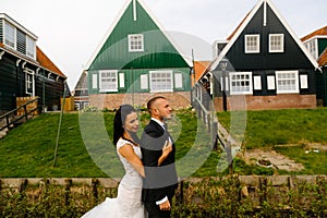 Wedding couple posing in front of a village