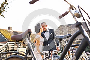 Wedding couple posing near bicycle