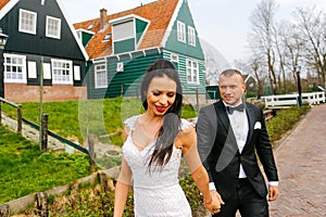 Wedding couple posing near houses