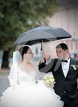 Wedding couple in rain