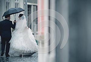 Wedding couple in rain