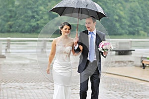 Wedding couple in a rainy day