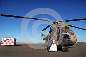 Wedding couple with retired military helicopter