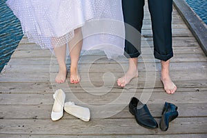 Wedding couple's feet standing on the wooden