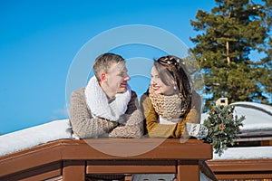 Wedding couple in a showy wither day, holding each other, rustic style short wedding dress. Girl brunette. beautiful bride winter