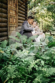 Wedding couple sits with glasses in hand