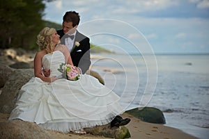 Wedding couple on stony beach