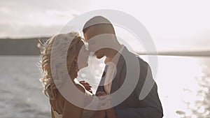 Wedding couple together on the slope of the mountain. Lovely groom and bride. Slow motion