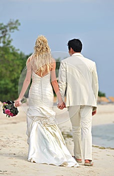 Wedding couple walking on beach