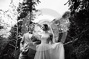 Wedding couple walking near the lake in Tatra mountains in Poland. Morskie Oko. Black and white photo option