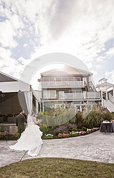 Wedding couple walking into outdoor reception