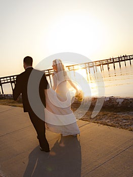 Wedding couple walking into sunset