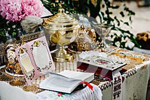 Wedding crowns in church ready for marriage ceremony. close up. Bible, crown, bowl, Certificate of the glans in the church on