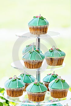 Wedding cupcake tower stand with turquoise cakes.