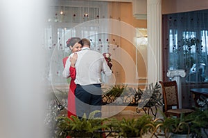 Wedding: cute newlyweds, bride and groom, couple slowly dancing together