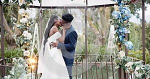 Wedding, dance and kiss, black couple in garden with love, celebration and excited for future together. Gazebo, man and