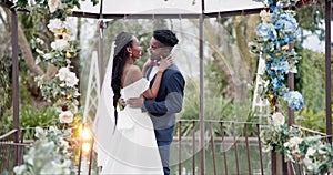 Wedding, dance and kiss with happy black couple in garden with love, celebration and excited for future together. Event