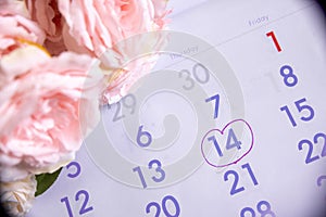 Wedding date anniversary calendar and blue flower bouquet.A couple of love planning a honeymoon next month